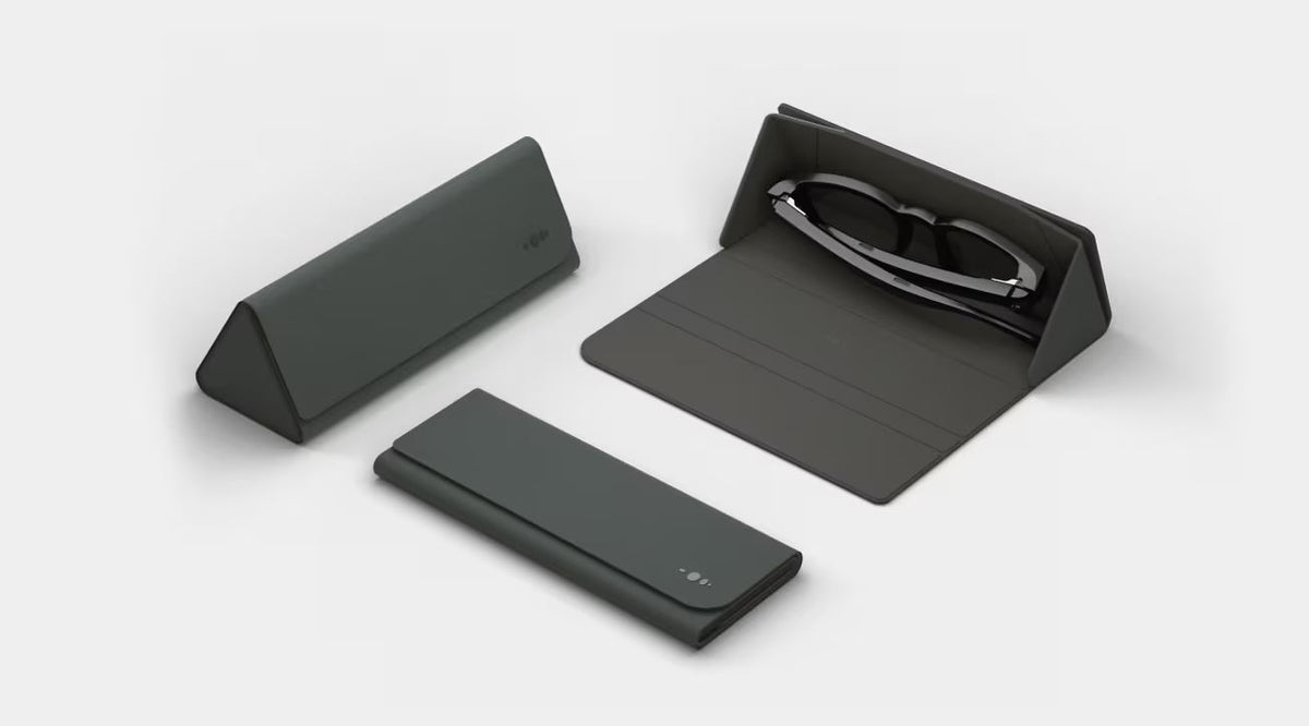 Set of black eyeglasses and cases on a white background